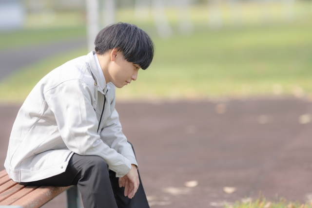落ち込む作業服男性