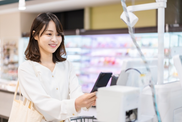 電子マネー決済をする若い女性